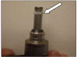 7. Place the resizing tool (flange up) over the seal. Twist the tool slightly