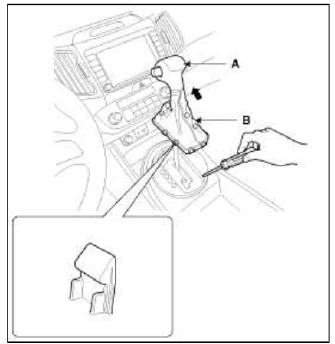 2. Using a screwdriver or remover, remove the console upper cover (A).